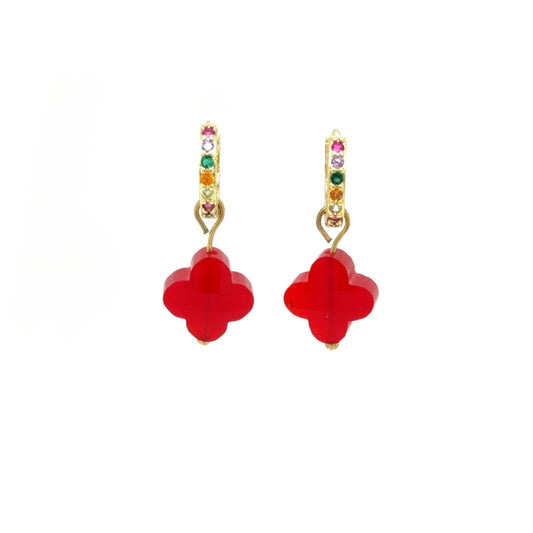 Huggie gold hoop earrings with rainbow zirconia stones and clover shaped charm in siam red