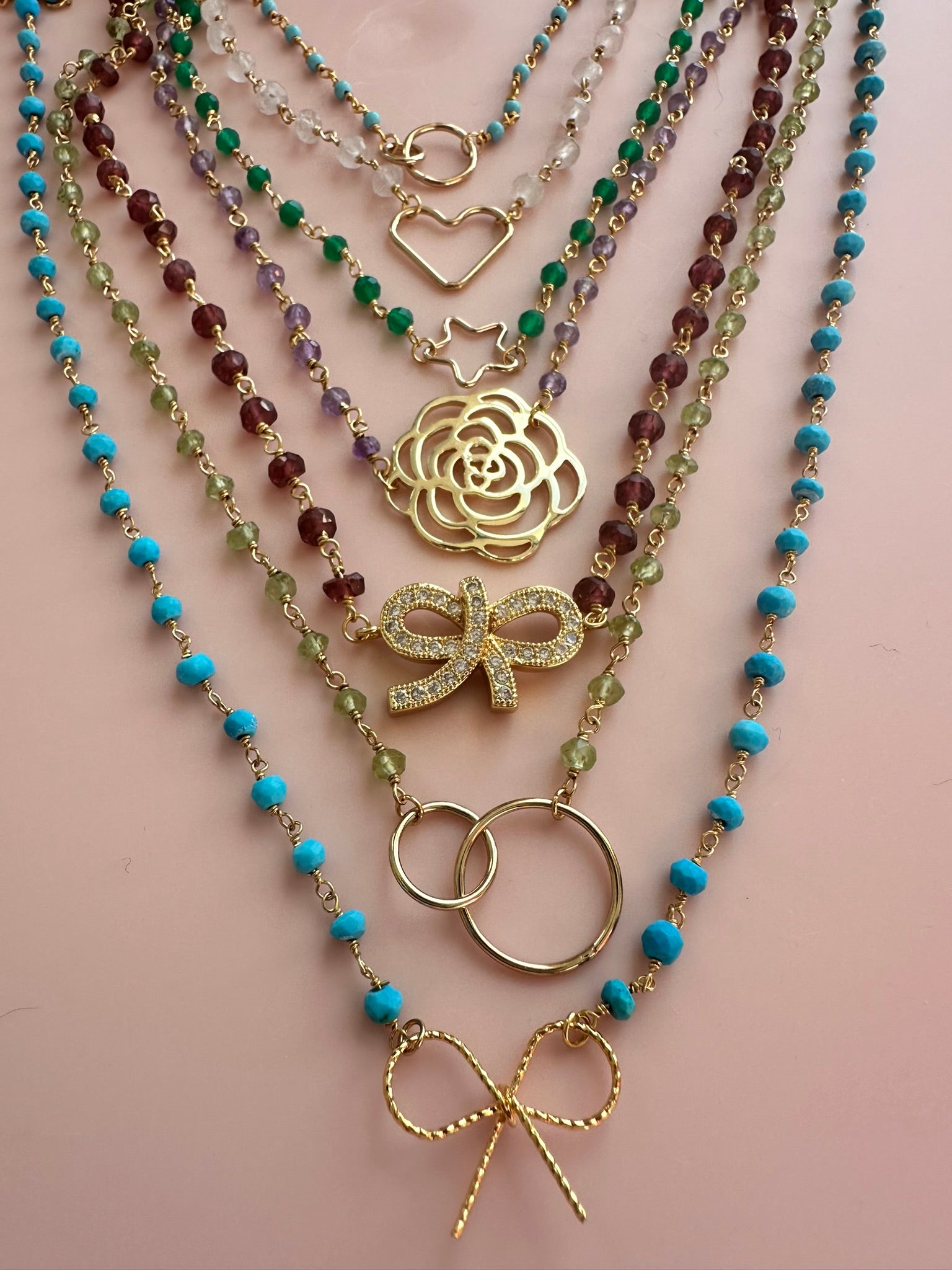 Group of multi coloured rosary gold neckacles