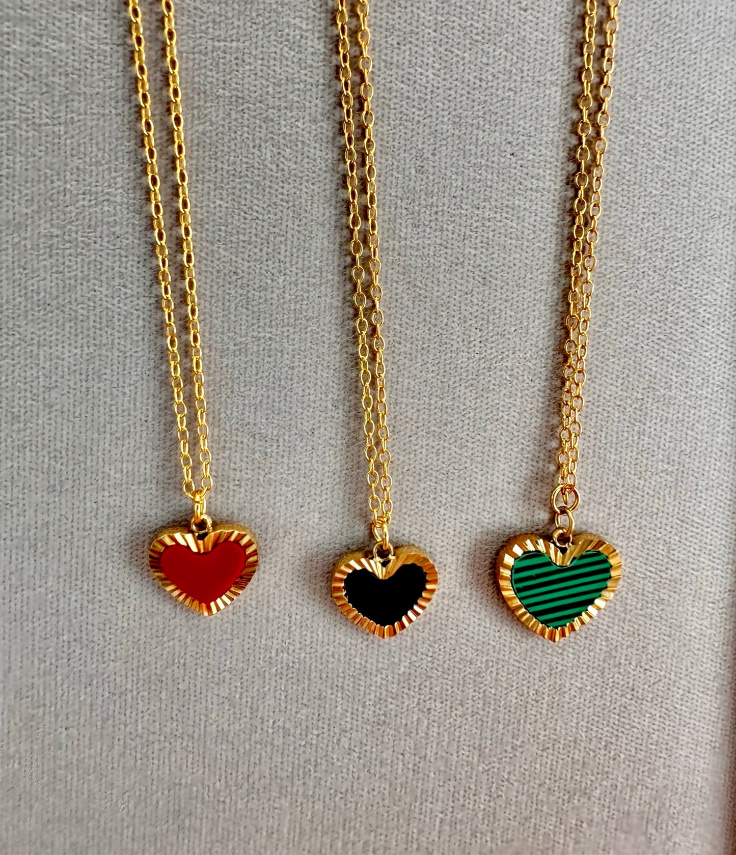 gold chain necklaces with one heart shaped charms in red, black and gold