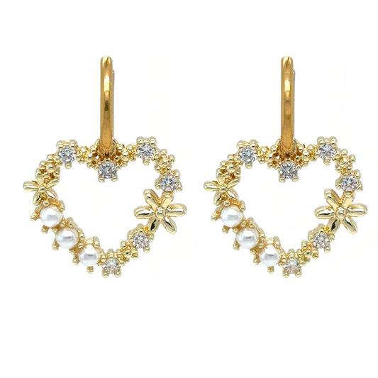 Delicate gold hoop earrings with large heart charms decorated with pearls and crystals