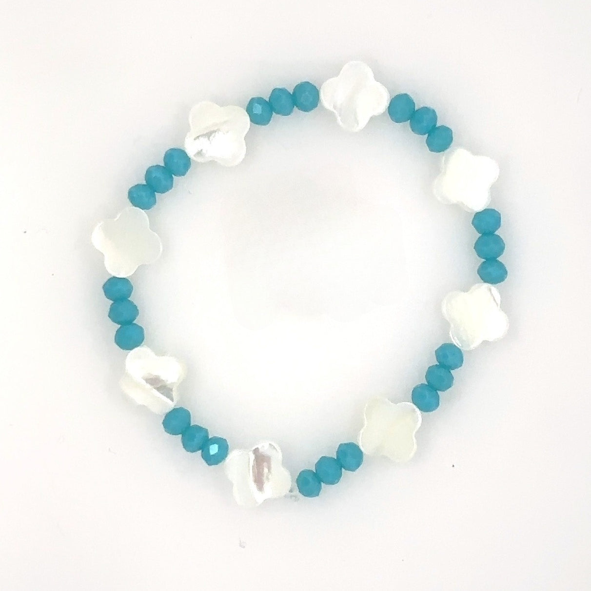 Bracelet with blue beads and white flower-shaped charms on a white background