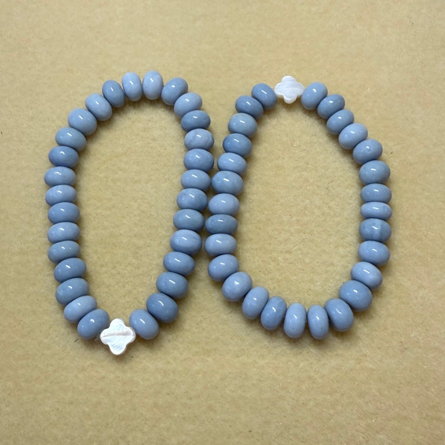 Two bracelets made with 9mm light blue opal rondelle beads