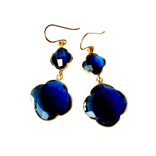 Pair of blue flower-shaped earrings with gold accents on a white background