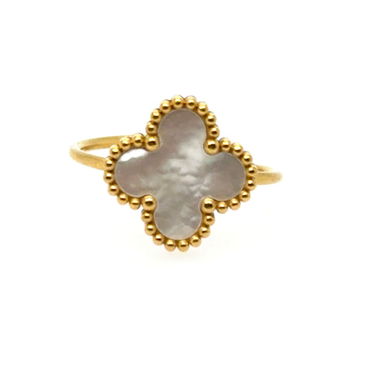 Gold ring with a clover-shaped mother of pearl design and adjustable band on a white background