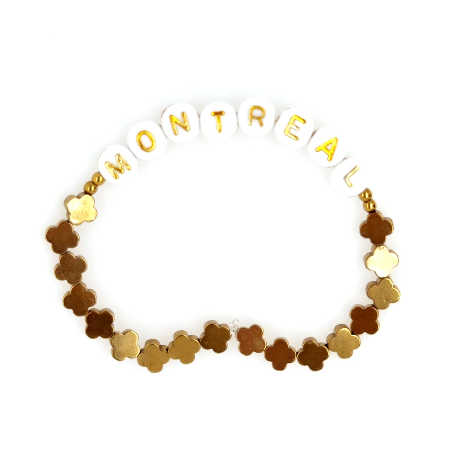 Bracelet with gold and brown flower-shaped beads spelling 'MONTRéAL' on a white background