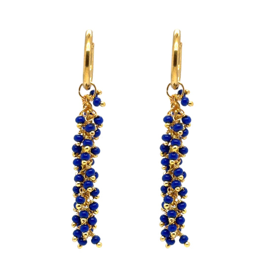 Delicate gold hoops with bright navy blue glass beads arranged in dangling clusters