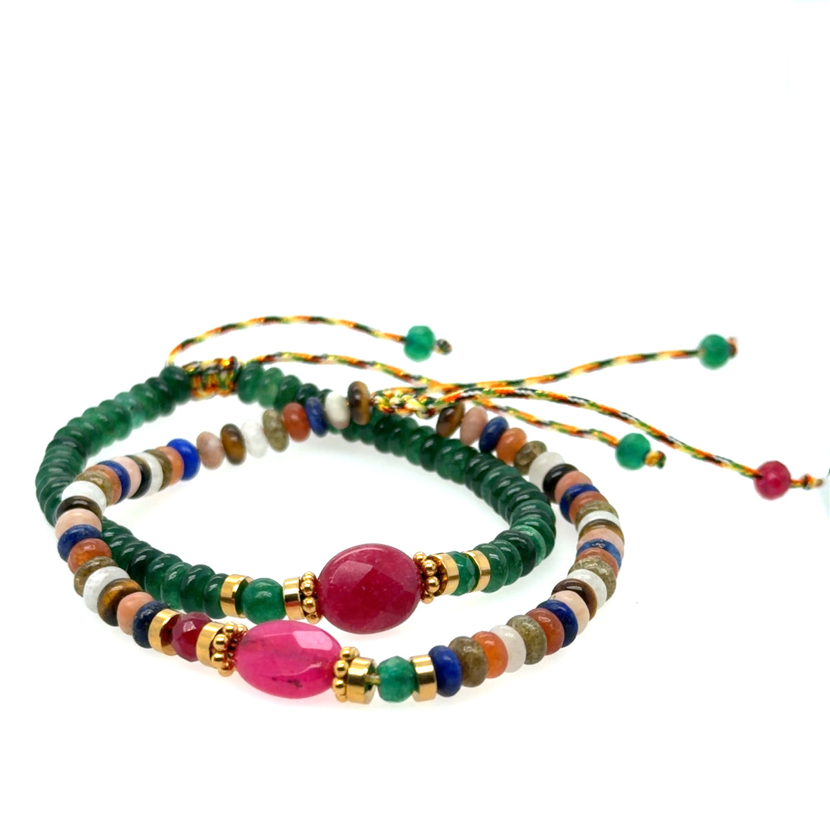 Two beaded string bracelets with green beads, colorful accent beads, and large pink gemstone in the middle, displayed on a clean white background.