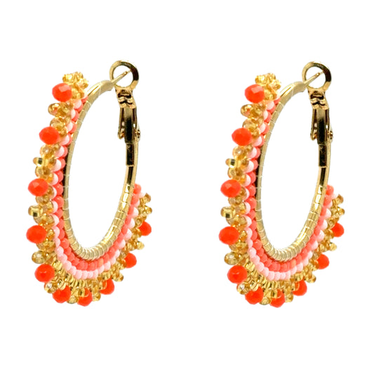 These lovely big beaded hoop earrings are orange and gold 