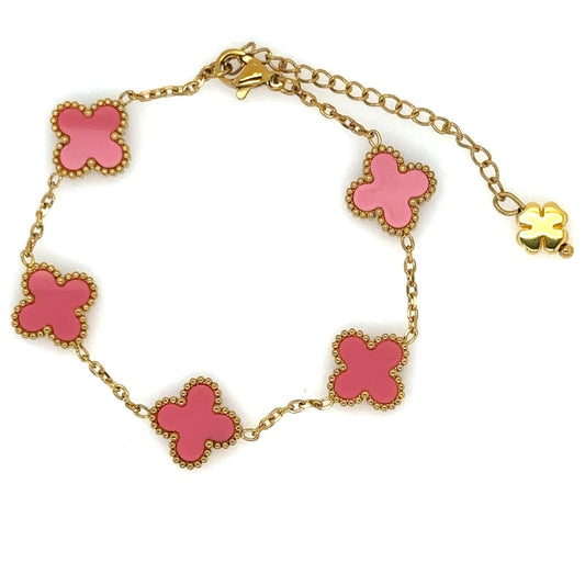 gold bracelet has five small clover charms in pink enamel