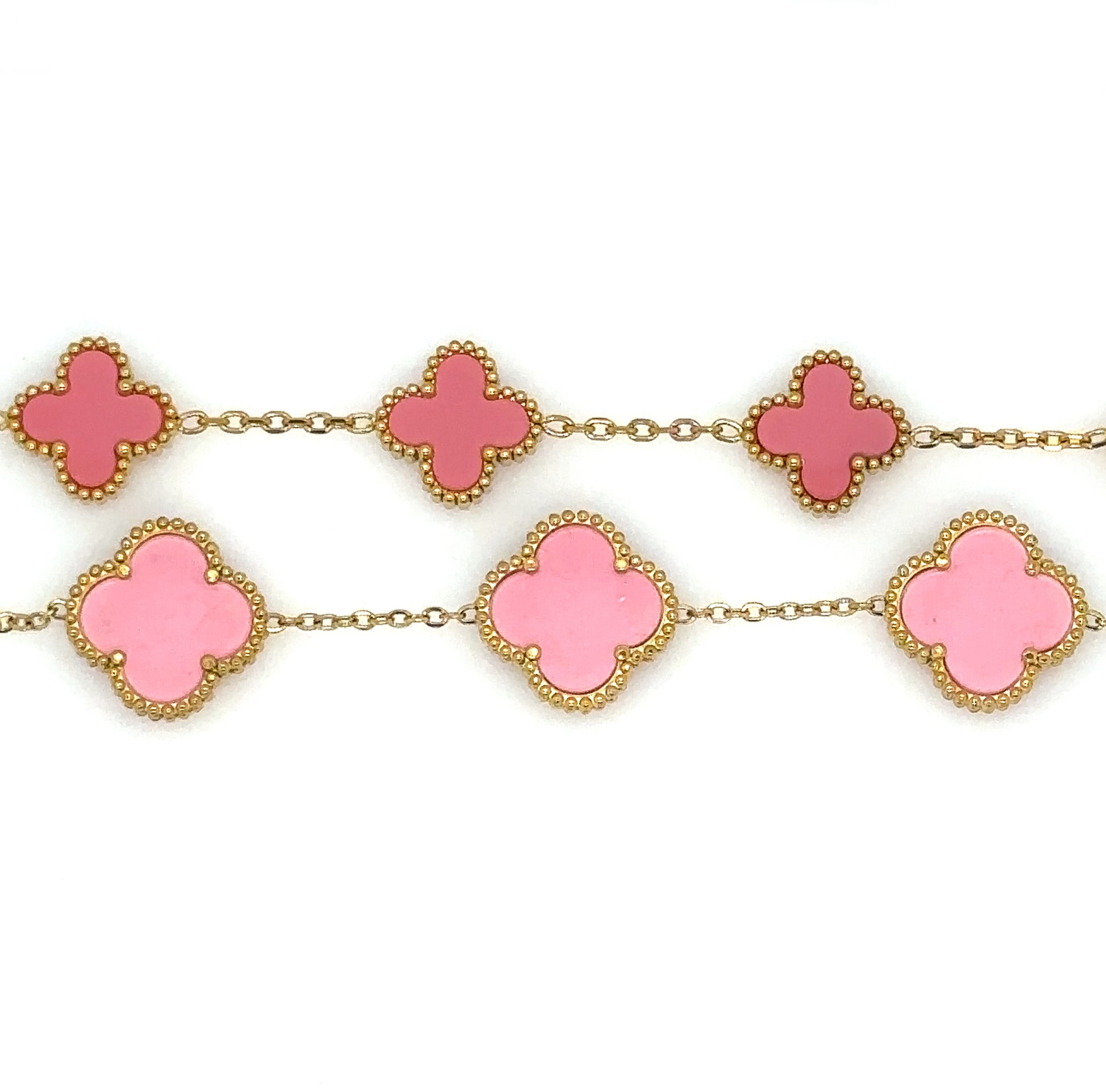 Two gold bracelets with five small and large clover charms in pink enamel