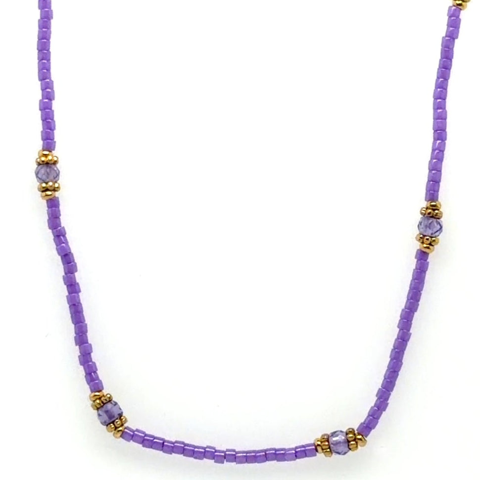Delicate necklace with tiny purple and gold beads.