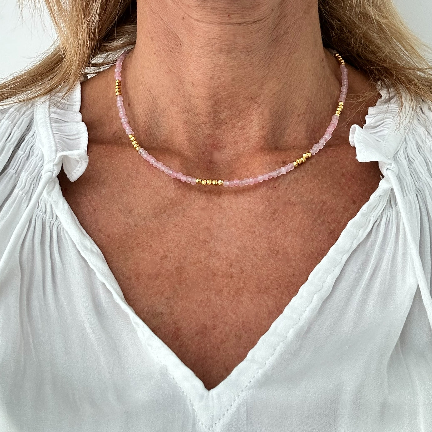 Necklace with pretty pink Rose Quartz beads and bright golden pyrite beads all around worn on model