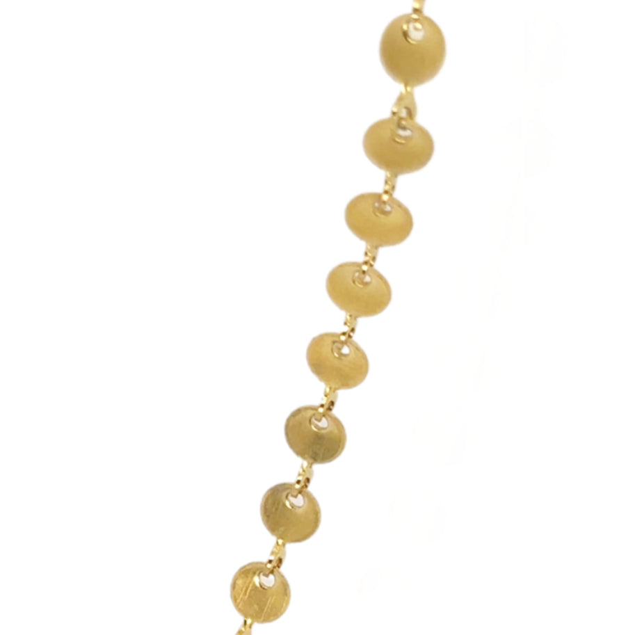 Gold necklace with round disc chain links on a white background