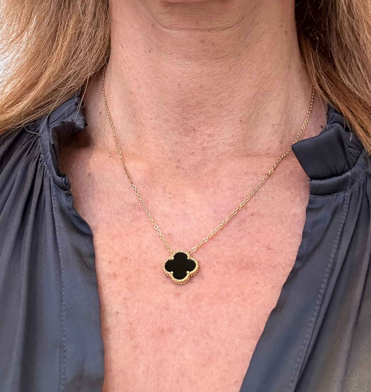 Delicate gold chain necklace with black single clover