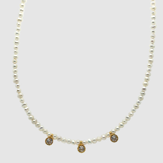 Elegant necklace with small Freshwater pearl beads and three small sparkly charms in the middle
