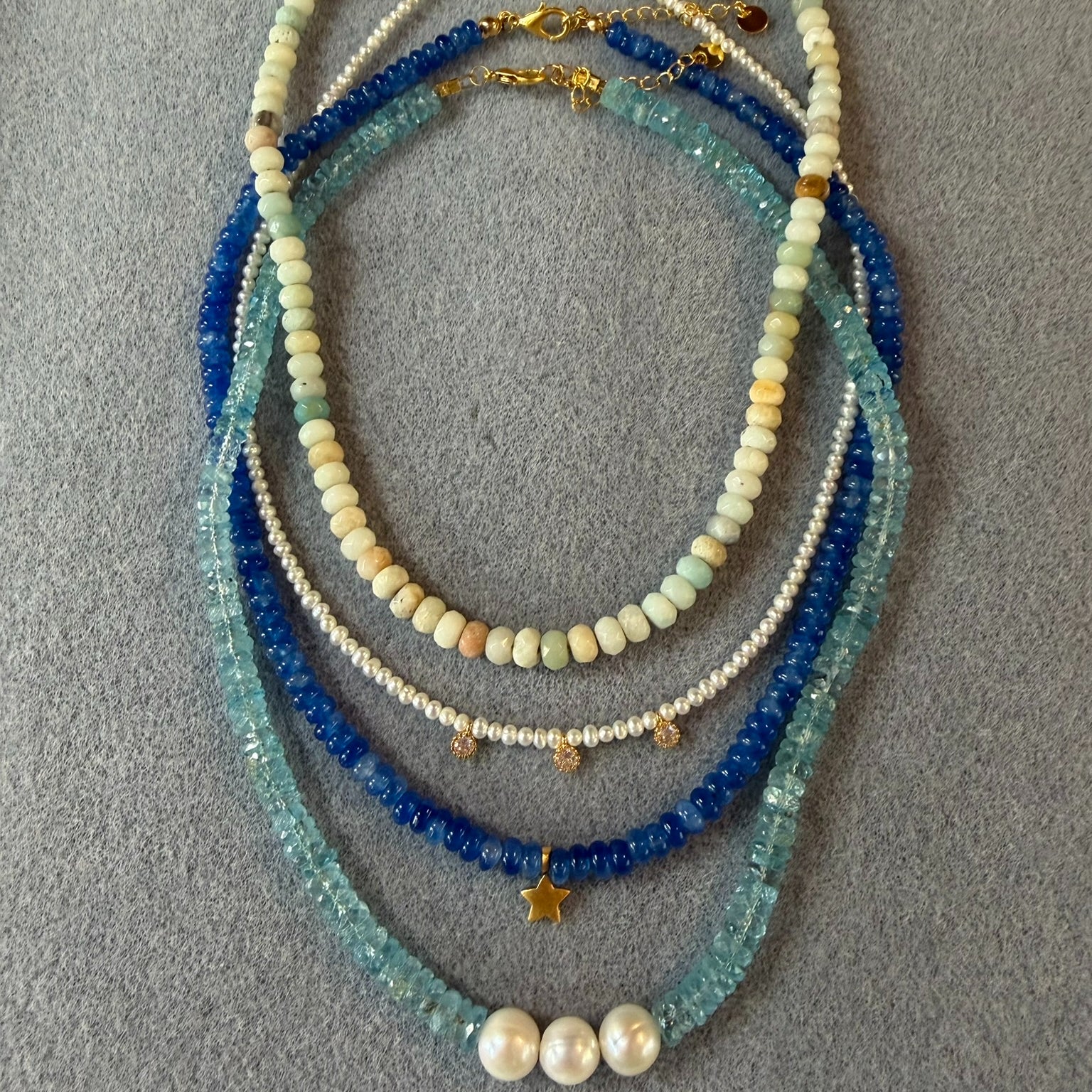 group  of rondelle bead necklaces in blue stones and pearls