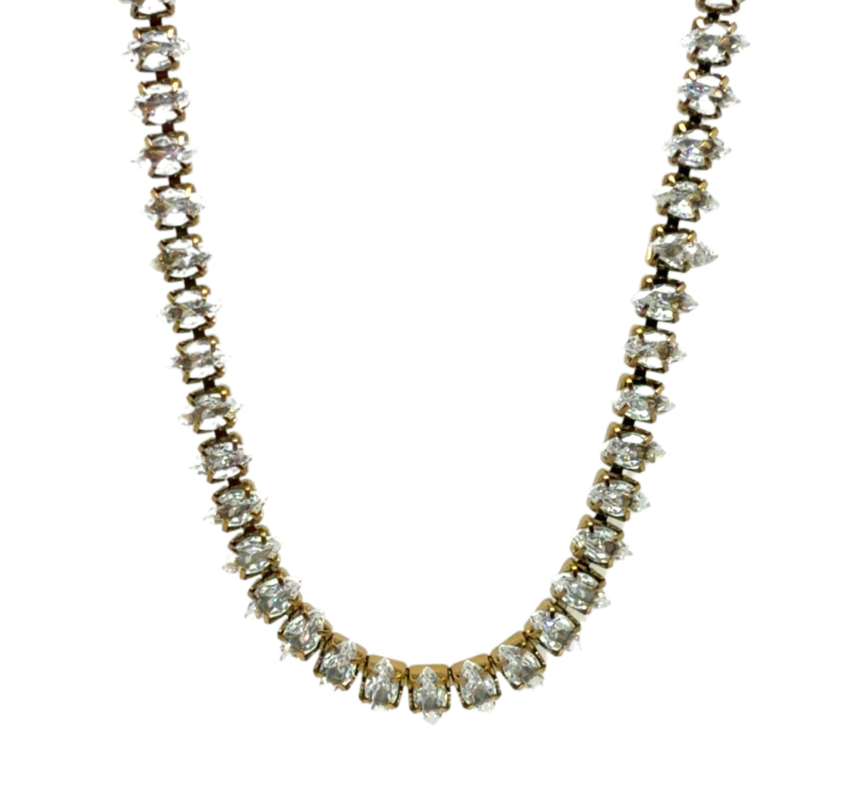 A yellow gold tennis necklace featuring a continuous row of round-cut clear gemstones in a prong setting, photographed against a solid white background.