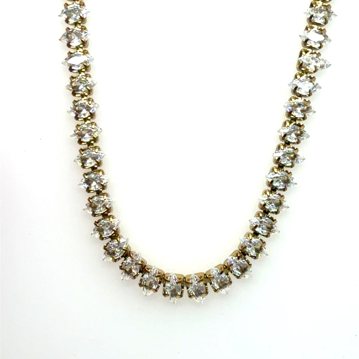 Sparkly tennis necklace with square rhinestones all around and small gold clover for luck on the clasp