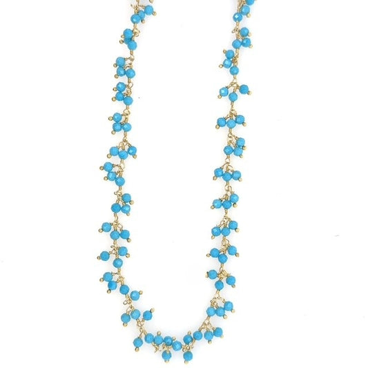 Gold necklace with bright turquoise gemstone beads arranged in clusters