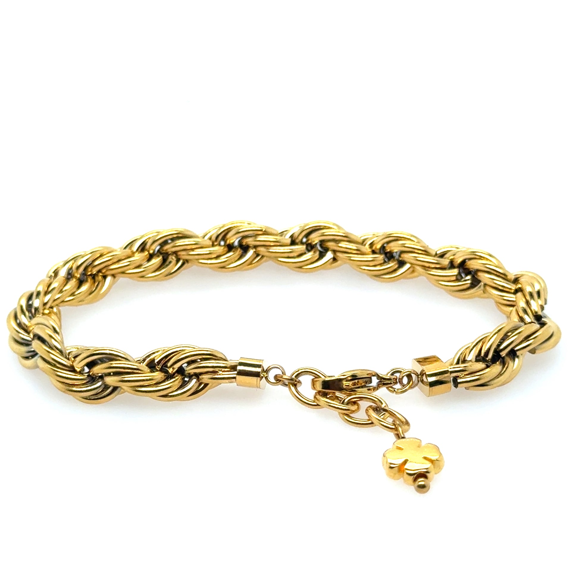 Gold braided bracelet with a clover charm on a white background