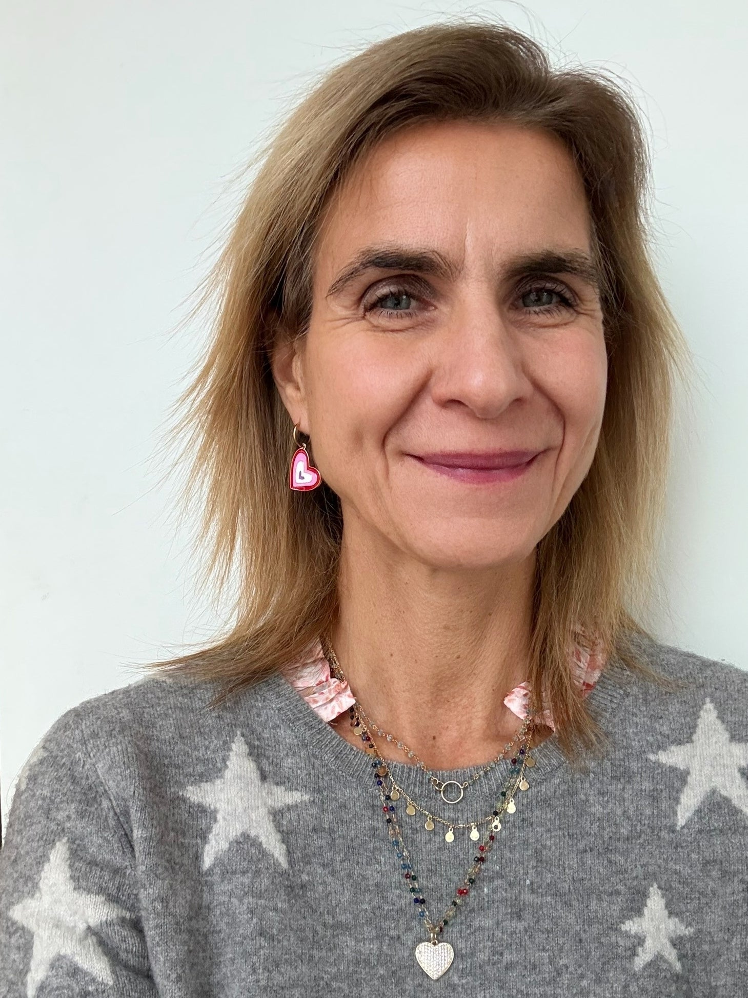 model wearing heart charm hoops and necklace