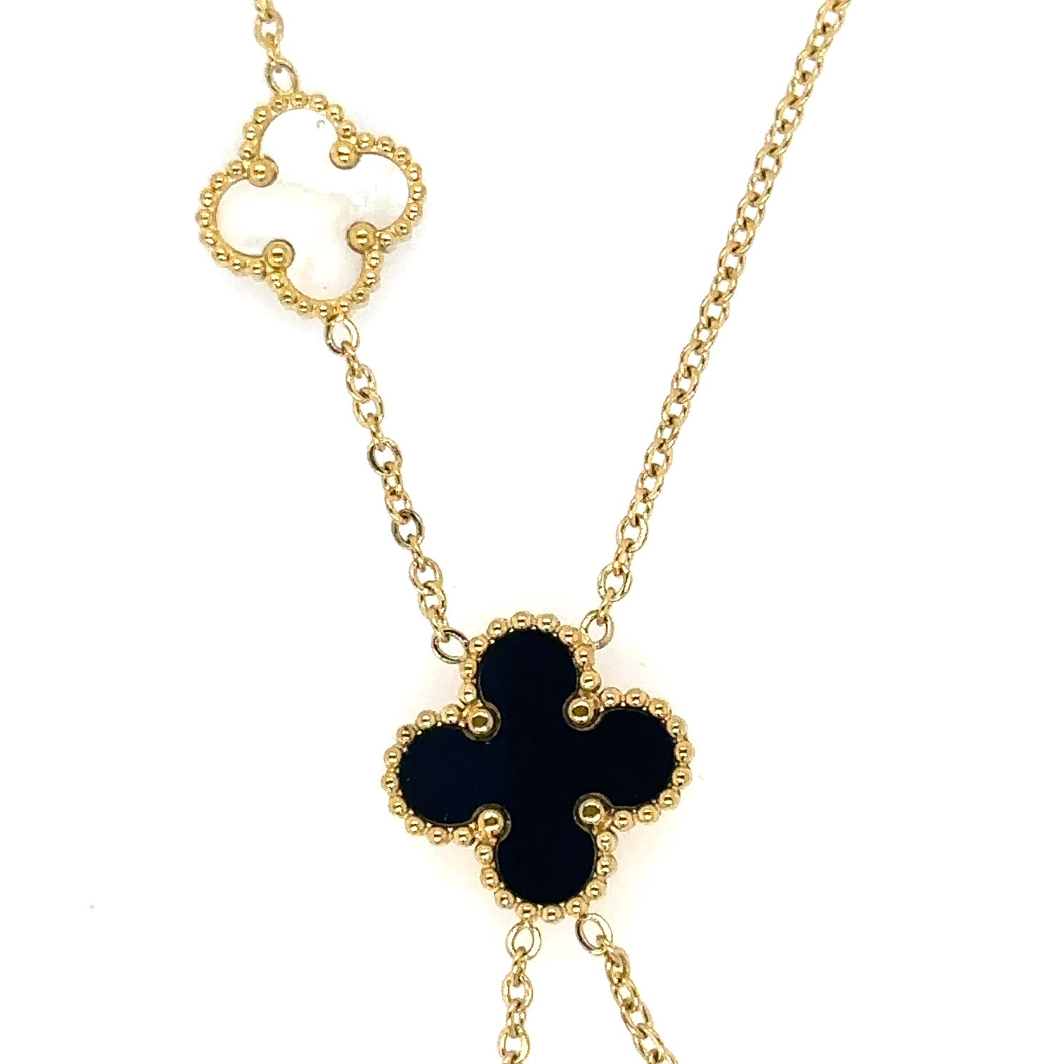 Lariat necklace with five small and medium sized reversible clover charms in black and white