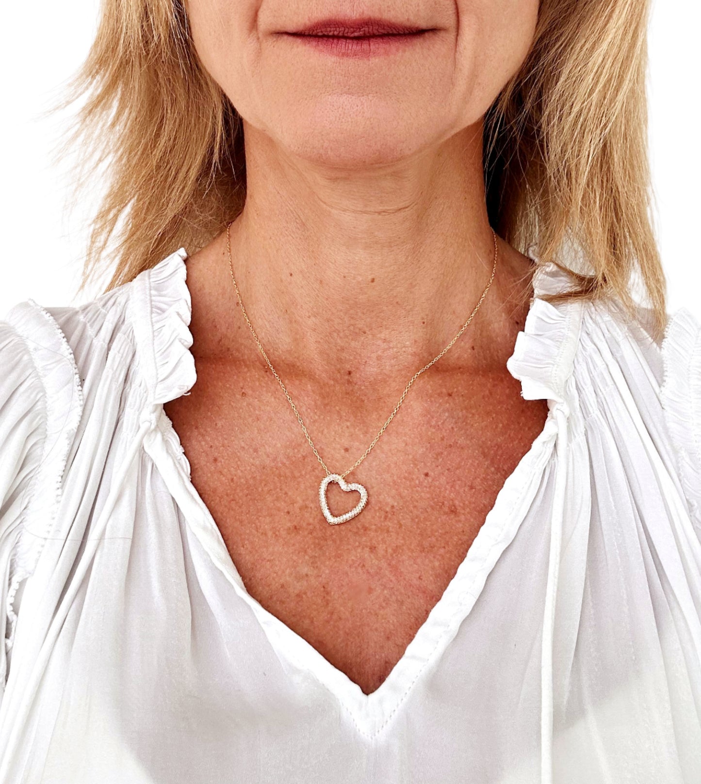 Delicate gold chain necklace with one large heart charm with sparkly zirconia white diamonds