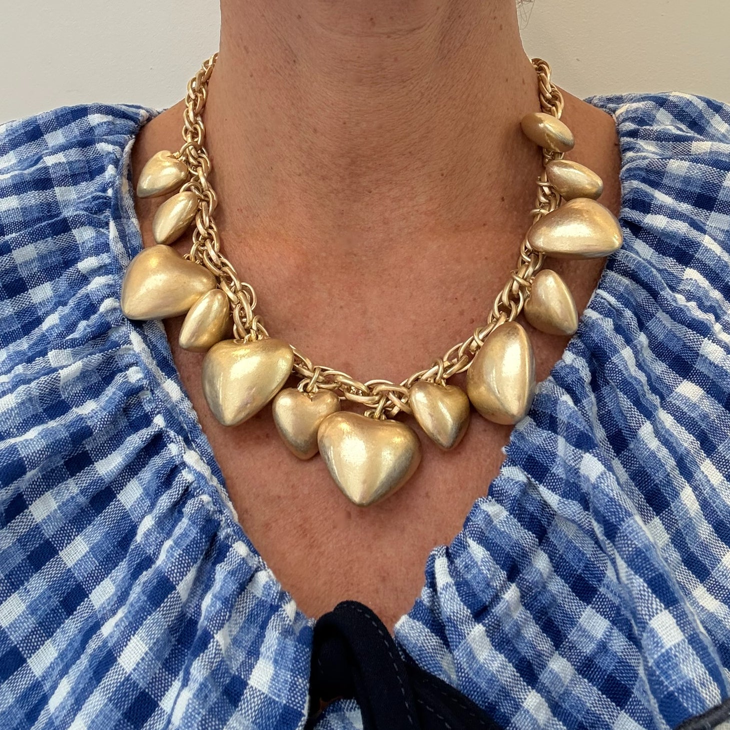 big heart gold necklace worn on woman