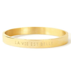 gold bangle which is engraved with the phrase: La Vie Est Belle - life is beautiful!