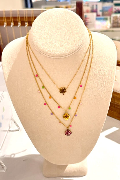 Delicate gold chain necklaces with one clover flat charm in gold and enamel