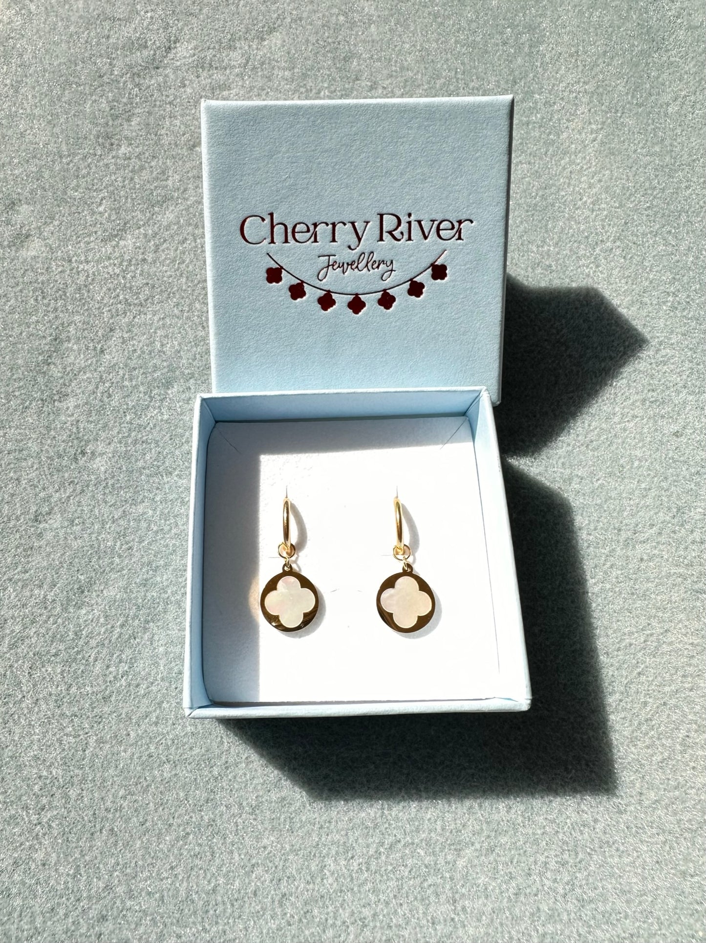 gold hoop earrings with mother of pearl clover and gold circle charms