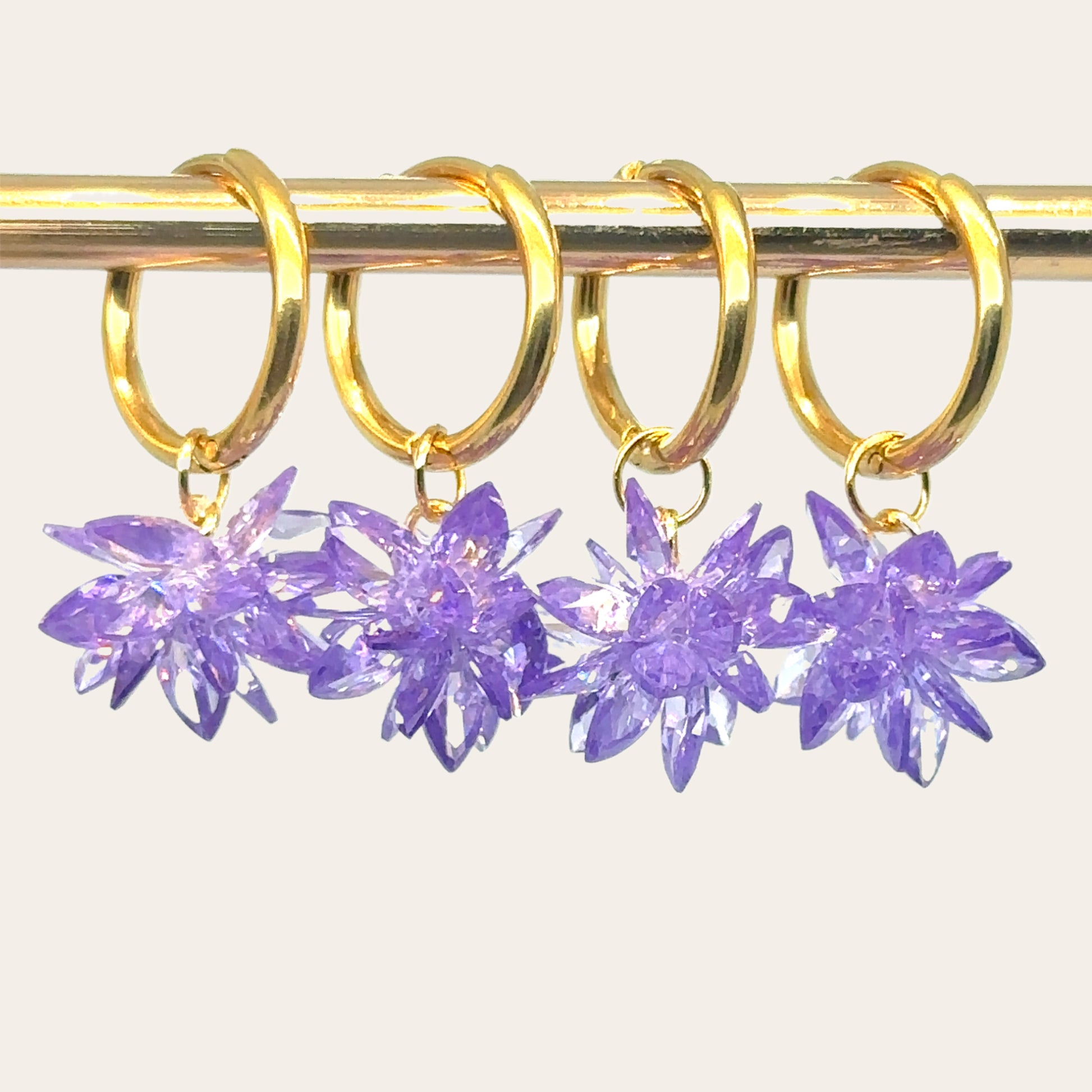 gold hoop earrings with purple crystal flower charms