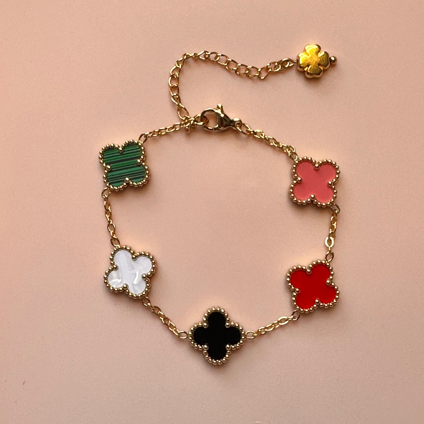 This lovely gold bracelet has five small clover charms in a rainbow of colours again