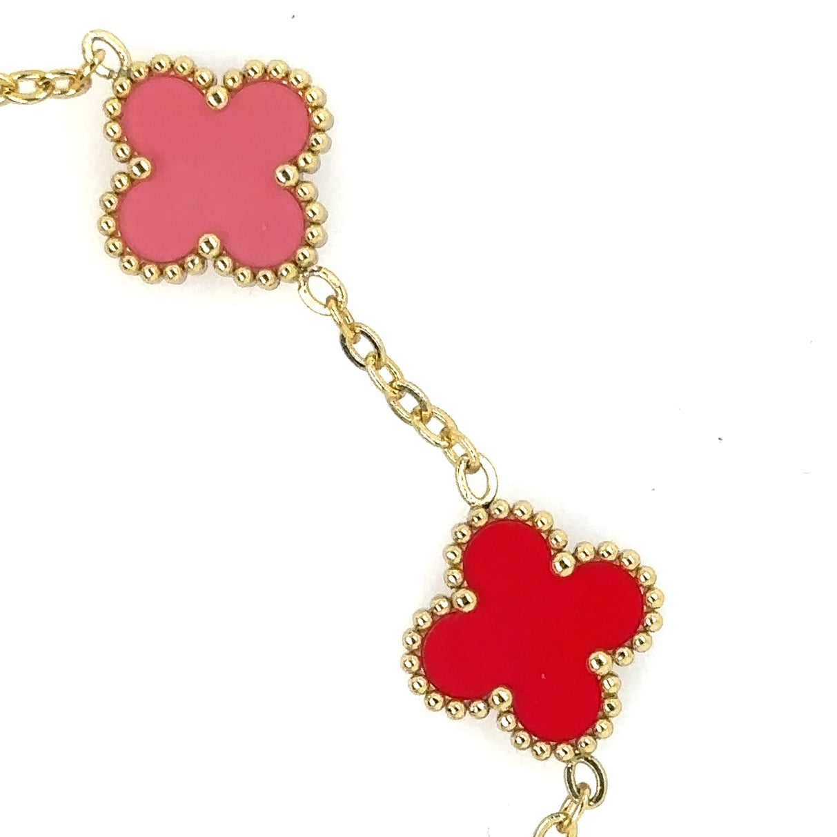 This lovely gold bracelet has five small clover charms in a rainbow of colours showing the pink and red colours