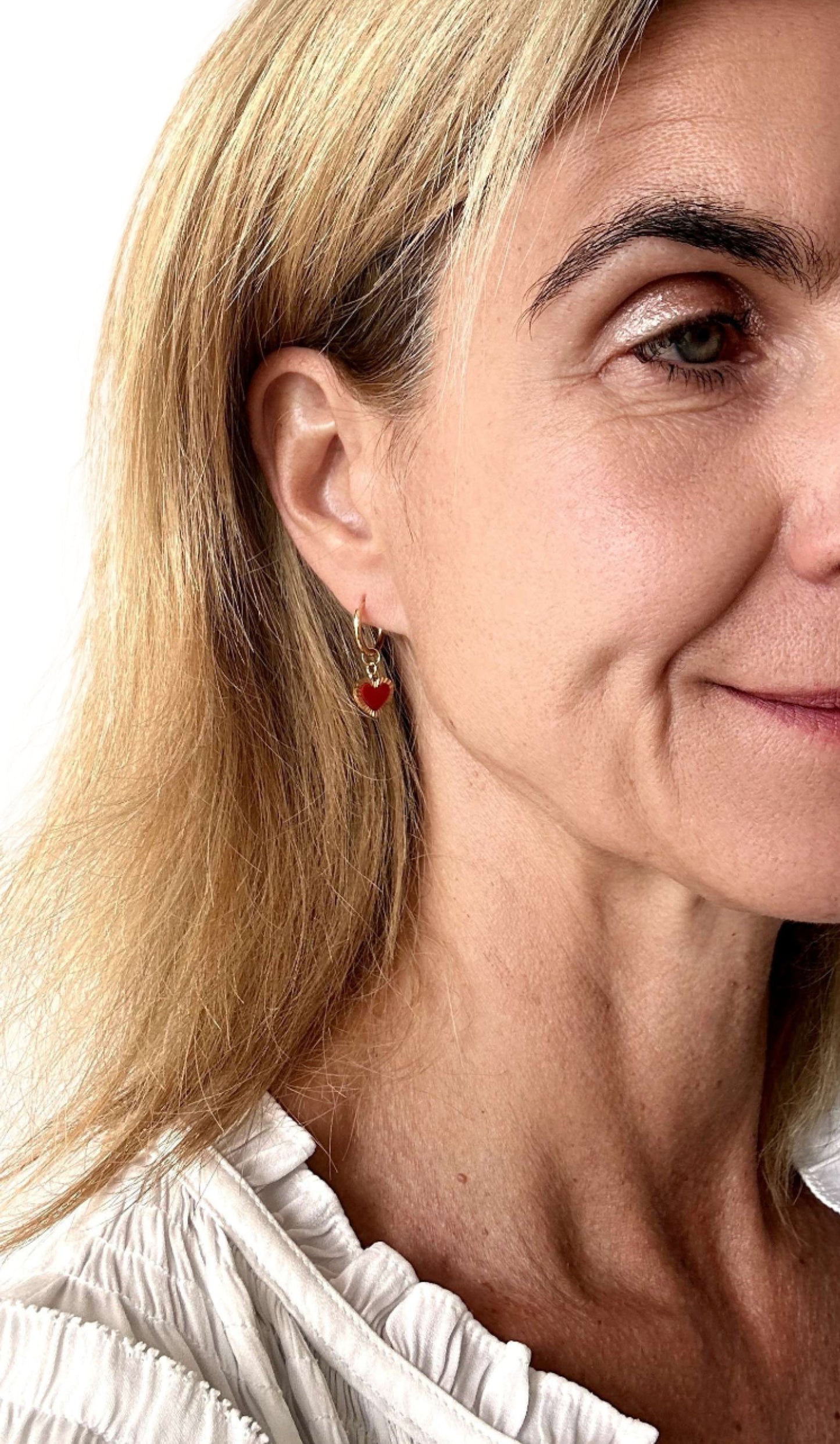 gold hoop earrings with red and gold heart shaped charms