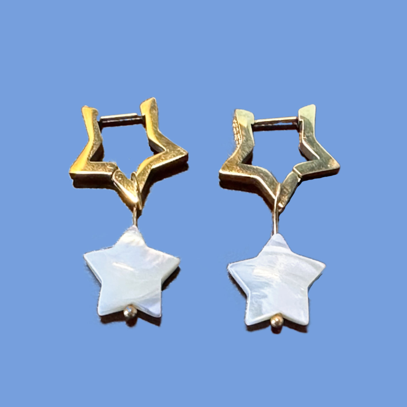 Star shaped gold hoop earrings with star shaped mother of pearl charms