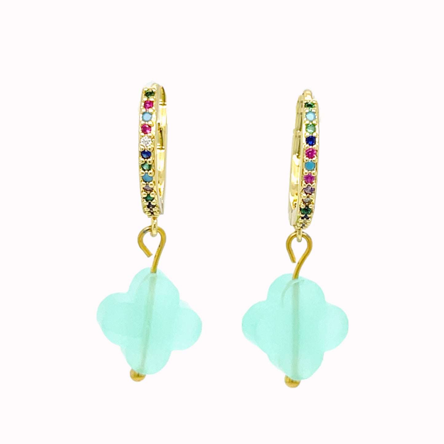 Gold hoop earrings with rainbow zirconia stones and clover-shaped glass charms in pastel green